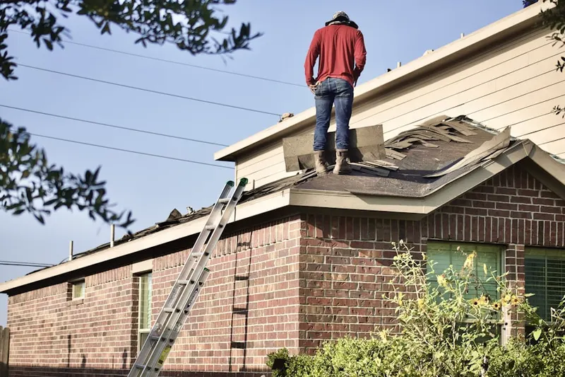 Professional roofer working on a residential roof in Alta Mesa East